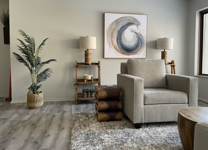 A comfortable armchair, soft lighting, and plants in Dr. Lamkin’s Akron office